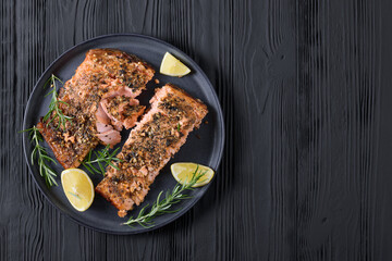 baked salmon fillet with lemon, rosemary on plate