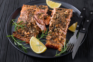 baked salmon fillet with lemon, rosemary on plate
