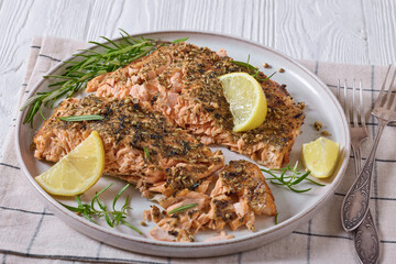 baked salmon fillet with lemon, rosemary on plate