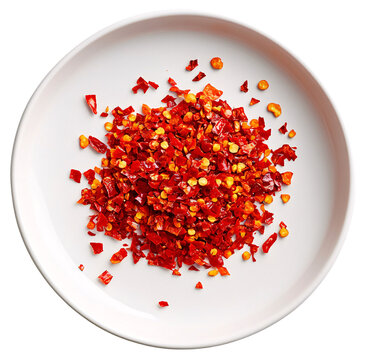 A small white dish filled with crushed red pepper flakes.