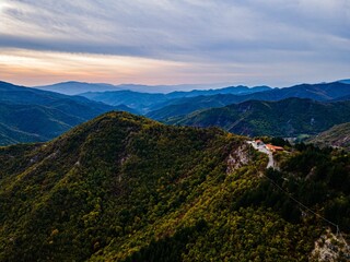 Aerial view of lush green mountains at sunset.