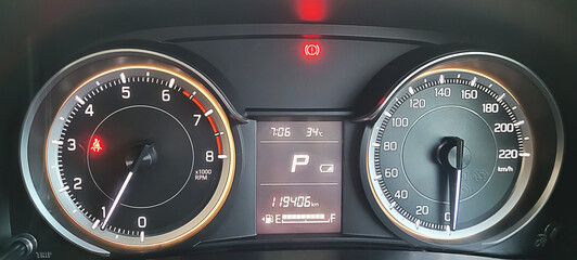 Close-up of car dashboard, speedometer and tachometer, modern car interior.