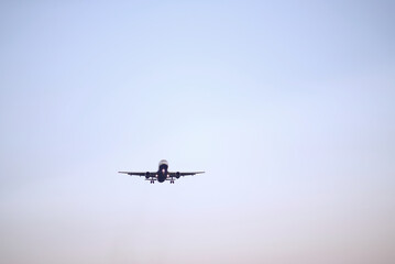 Passenger Airplane Landing Take-Off at Dawn with Clear Sky Background