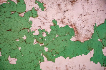 Chipped and peeling lead based paint on an old wall.