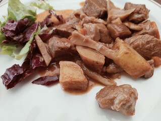 stew dish with potato and mushroom sauce
