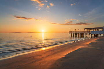 Follonica beach and shoreline with building on the sea at sunset. Tuscany, Italy