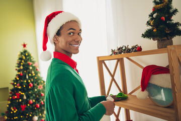 Photo of handsome good mood guy wear green sweater doing cleaning celebrating noel xmas indoors room home house