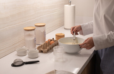 Woman at home in her kitchen cooking, woman hands, culinary blog, step-by-step recipe for cooking a dish, breakfast , recipe, plate and whisk for preparing breakfast