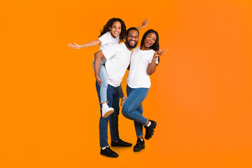 Spending Time With Family Is Fun. Full body length of excited African American man, woman and girl...