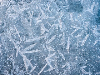ice texture on the lake water in winter outdoors with snow