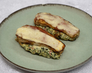 Healthy eating. Closeup view of stuffed zucchinis with ricotta, kani kama, spinach and gratin cheese