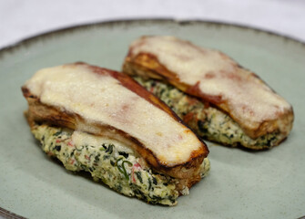 Healthy eating. Closeup view of stuffed zucchinis with ricotta, kani kama, spinach and gratin cheese
