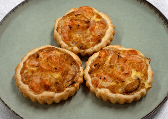 Seafood and bakery. Closeup view of three shrimp pies with gratin cheese