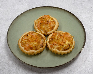 Seafood and bakery. Closeup view of three shrimp pies with gratin cheese