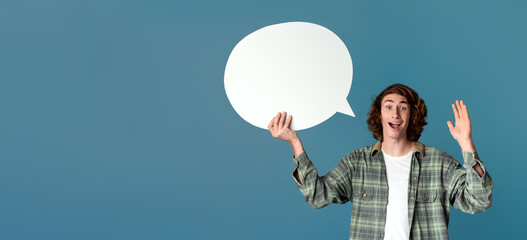 Cool guy holding speech bubble and waving on turquoise background, blank space