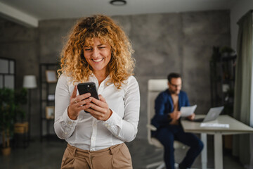 Portrait of adult businesswoman use mobile phone in the office