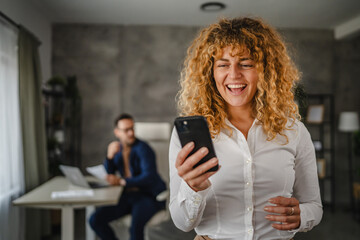 Portrait of adult businesswoman use mobile phone in the office
