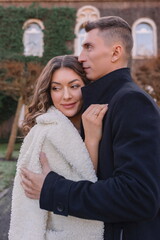 a joyful couple walking through a charming European city in winter. Wedding, love, street style