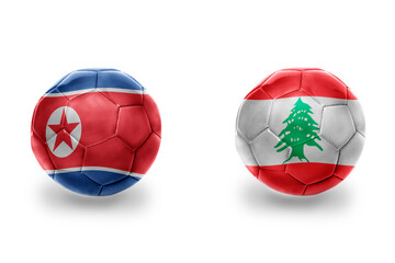 Obraz premium football balls with national flags of lebanon and north korea ,soccer teams. on the white background.