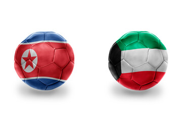 Obraz premium football balls with national flags of kuwait and north korea ,soccer teams. on the white background.