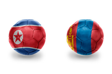 Obraz premium football balls with national flags of mongolia and north korea ,soccer teams. on the white background.