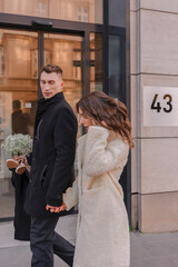 a joyful couple walking through a charming European city in winter. Wedding, love, street style