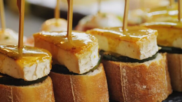 Italian or Spanish restaurant with traditional tapas pinchos food, Spanish cuisine, delicious tapas and cheese plate, bruschetta with cheese, olives dry tomatoes tasty sandwich bar appetizer, buffet