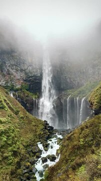 Waterfall with fog in countryside of Japan vertical setting.