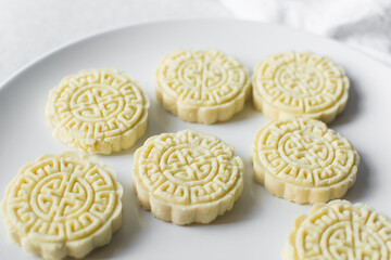 Overhead view of tuwon madara on a white plate, nigerian alawar madara milk candy, top view of milk...