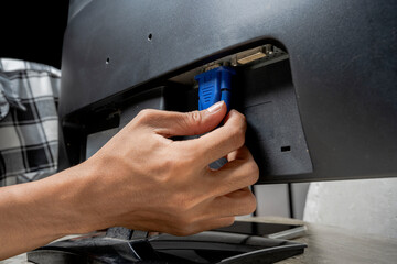 Man technician plug the television cable