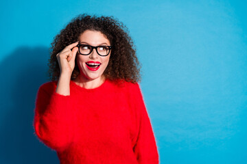Photo of attractive young woman look empty space touch specs interested dressed stylish red clothes...