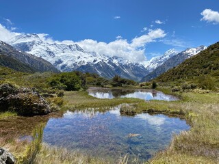 Fototapeta premium Hill top views of Aoraki Mount Cook reflecting in water at Red Tarns, Mount Cook National Park, New Zealand. Landscape with lake and mountains