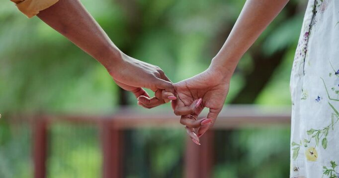 Holding hands, couple and valentines day for trust outdoor with care, travel support and nature date. Loyalty, people and partner with love, marriage commitment and bonding together for pinky promise
