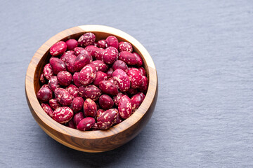 Red and White Beans in Wooden Bowl on Slate