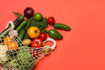 Delivery of vegetarian products. Bag with different vegetables and fruits on red background, top view