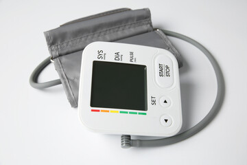 Blood pressure measuring device on white background, closeup