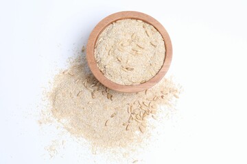 Oat bran in bowl and grains isolated on white, top view