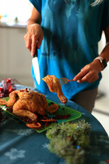 carving a beautifully roasted turkey, a centerpiece of the Christmas feast. This moment reflects the cherished traditions of holiday cooking and the warmth of family celebrations