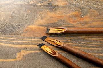Set of calligraphy reeds covered ink on wooden background