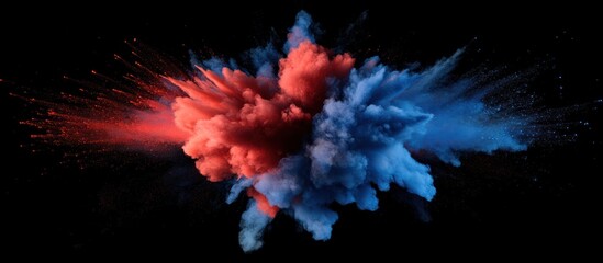 Abstract red and blue powder explosion on black background.