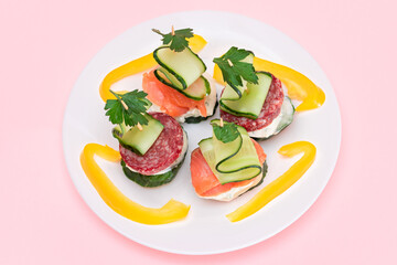 Canapes without Bread with Fresh Salmon, Salami, Cucumber, Greens and Cream Cheese on White Plate -...