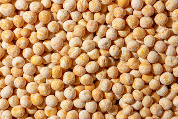 Uncooked Yellow Polished Peas Background. A Culinary Canvas of Dry Yellow Peas, Creating a Lively and Textured Background for Gourmet Cooking. Scattered Raw Polished Peas. Healthy Eating Ingredients
