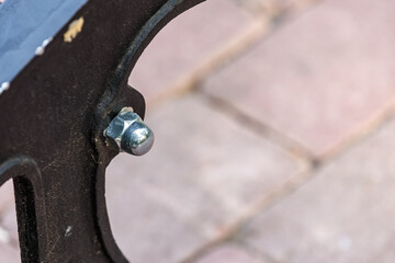 A bolt is sitting on a brick sidewalk
