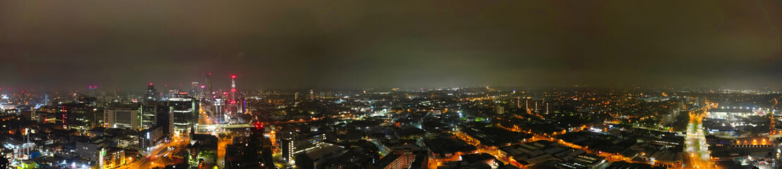 Fototapeta premium Aerial Panoramic View of Illuminated Downtown Buildings at Central Birmingham City Centre During Night at Midlands, England, United Kingdom. Drone's Camera Footage was Captured on November 4th, 2024.