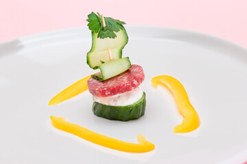 Canapes without Bread with Salami, Cucumber, Greens and Cream Cheese on White Plate. Easy Breakfast. Diet Food. Quick and Healthy Sandwiches. Healthy Snacks with Tasty Fillings
