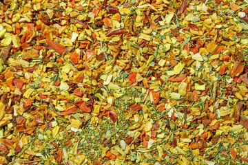 Vibrant and Colored Vegetable Seasoning Mix: A Culinary Canvas of Aromatic Seasoning - Textured Background for Gourmet Cooking. The Harmonious Combination of Fresh Herbs and Spices - Top View