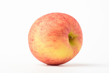 Fresh ripe apple with tiny water drops on white background