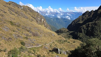 Inca Trail and clouds Andes Mountains landscape. Scenery views of the Andes Mountain range in Peru.