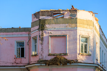 A building with a pink exterior and a large window