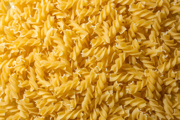 Uncooked Fusilli Pasta: A Culinary Canvas of Spiral Macaroni, Creating a Lively and Textured...